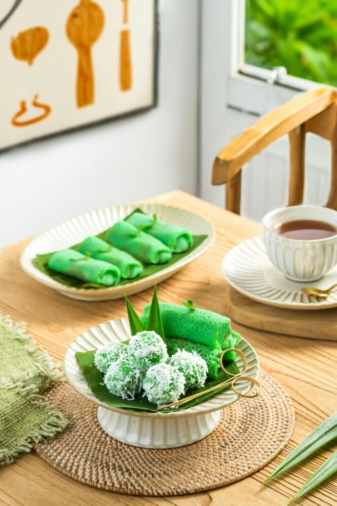 Delicious Indonesian desserts served in a cozy dining setting with natural light.