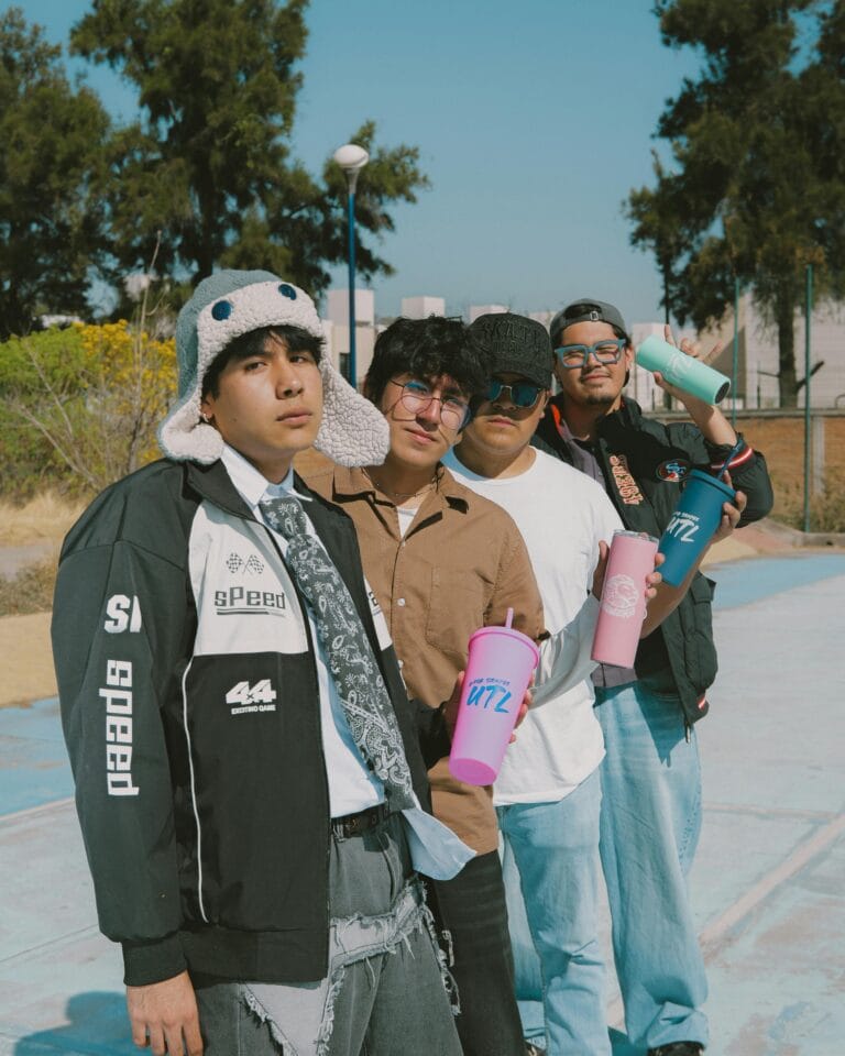 Group of young adults holding vibrant tumblers outdoors in León, Mexico.